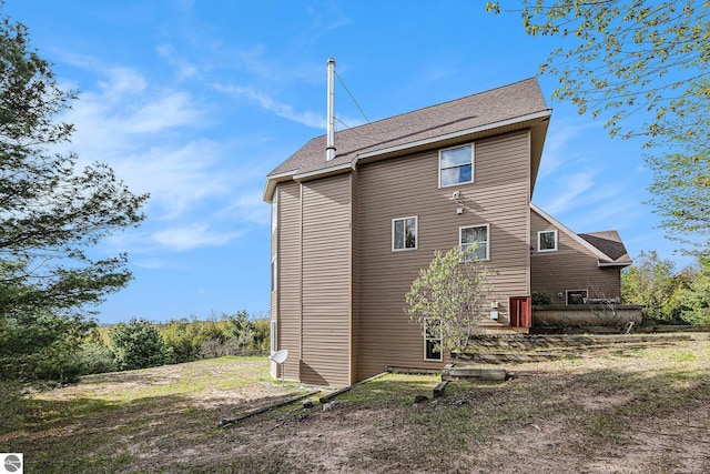 3290 Sumac Trl, Frankfort, MI 49635 - view of side of property featuring a shingled roof