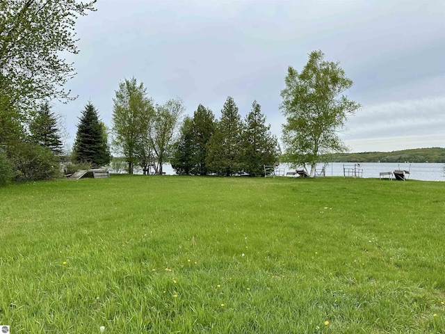 3290 Sumac Trl, Frankfort, MI 49635 - view of grassy yard featuring a water view