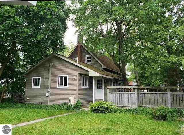 314 W Ninth St, Traverse City, MI 49684 - view of home's exterior with a chimney