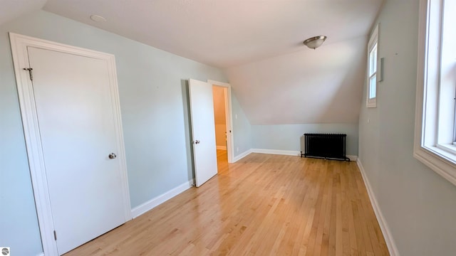 314 W Ninth St, Traverse City, MI 49684 - additional living space featuring lofted ceiling, radiator heating unit, light wood-style floors, baseboards, and healthy amount of natural light
