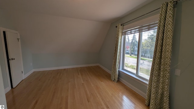 314 W Ninth St, Traverse City, MI 49684 - additional living space featuring light wood finished floors, lofted ceiling, and baseboards