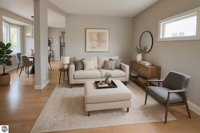 314 W Ninth St, Traverse City, MI 49684 - living room with light wood finished floors, a chandelier, and healthy amount of natural light