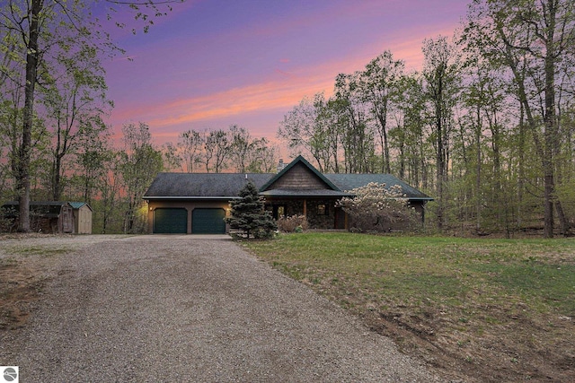 5301 Durga Rd, Williamsburg, MI 49690 - view of front of property featuring driveway and a garage