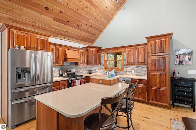 5301 Durga Rd, Williamsburg, MI 49690 - kitchen featuring stainless steel appliances, wine cooler, light countertops, light wood finished floors, and high vaulted ceiling