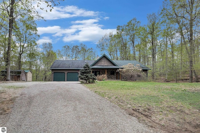 5301 Durga Rd, Williamsburg, MI 49690 - view of front of house with a garage, driveway, and a front yard