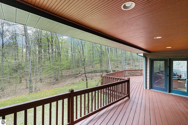 5301 Durga Rd, Williamsburg, MI 49690 - wooden deck with a wooded view and a lawn