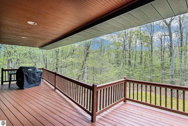 5301 Durga Rd, Williamsburg, MI 49690 - wooden deck with a wooded view and a grill