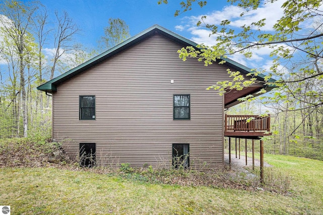 5301 Durga Rd, Williamsburg, MI 49690 - view of side of property with a wooden deck and a lawn