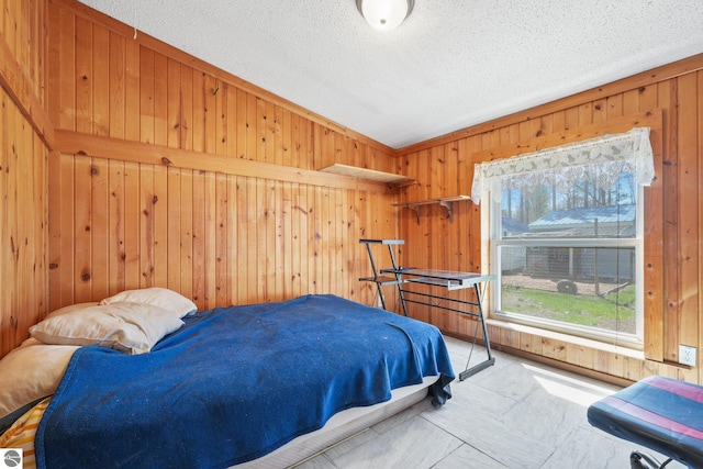 1493 NE Laura Ln, Kalkaska, MI 49646 - bedroom featuring wood walls, a textured ceiling, and vaulted ceiling