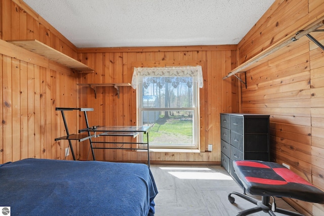 1493 NE Laura Ln, Kalkaska, MI 49646 - bedroom with wooden walls and a textured ceiling