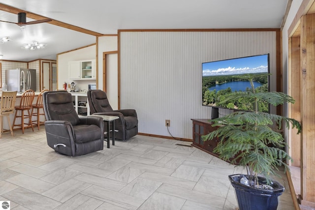 1493 NE Laura Ln, Kalkaska, MI 49646 - living room featuring lofted ceiling, baseboards, and wood walls