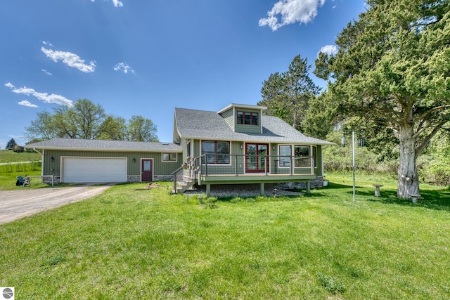 9560 S Cedar Rd, Cedar, MI 49621 - view of front of home featuring driveway, a front yard, a deck, and a shingled roof