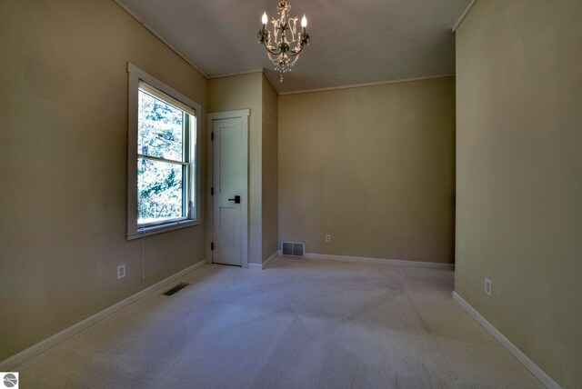 9560 S Cedar Rd, Cedar, MI 49621 - carpeted spare room with a chandelier, ornamental molding, and baseboards