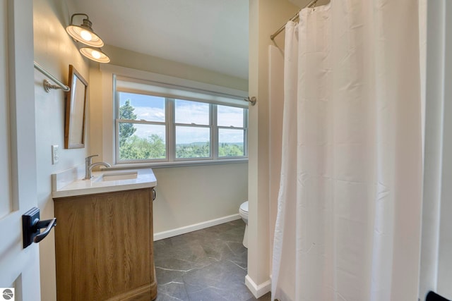9560 S Cedar Rd, Cedar, MI 49621 - bathroom with toilet, vanity, baseboards, and curtained shower