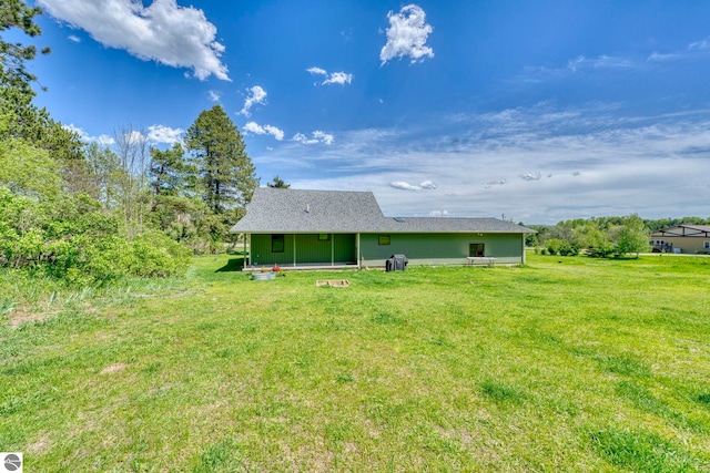 9560 S Cedar Rd, Cedar, MI 49621 - rear view of house with a yard