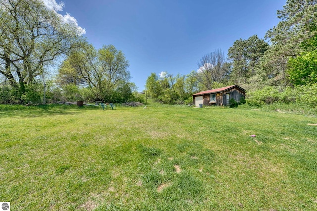 9560 S Cedar Rd, Cedar, MI 49621 - view of grassy yard with an outdoor structure and an outbuilding
