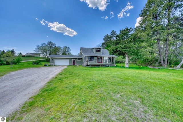 9560 S Cedar Rd, Cedar, MI 49621 - view of front of home featuring a garage, covered porch, a front lawn, and driveway
