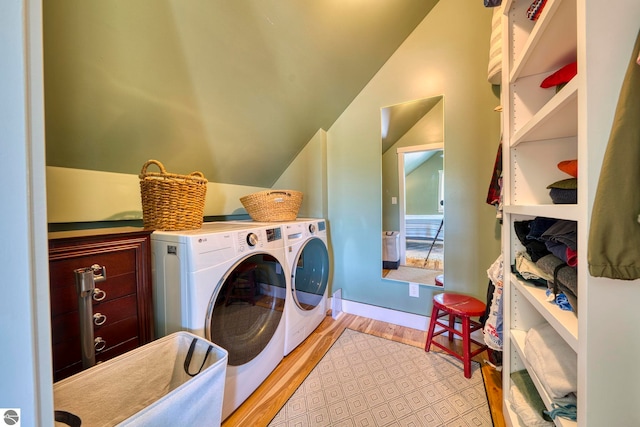 2494 N Setterbo Rd, Suttons Bay, MI 49682 - washroom featuring independent washer and dryer, wood finished floors, cabinet space, and baseboards