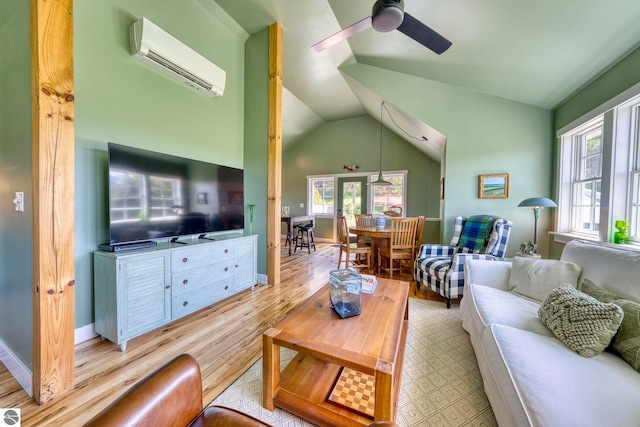 2494 N Setterbo Rd, Suttons Bay, MI 49682 - living area featuring a wall mounted air conditioner, wood finished floors, ceiling fan, and lofted ceiling