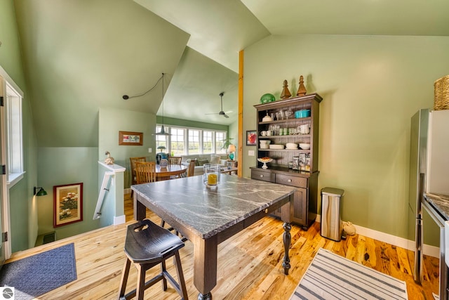 2494 N Setterbo Rd, Suttons Bay, MI 49682 - kitchen featuring vaulted ceiling, a ceiling fan, light wood-type flooring, and baseboards