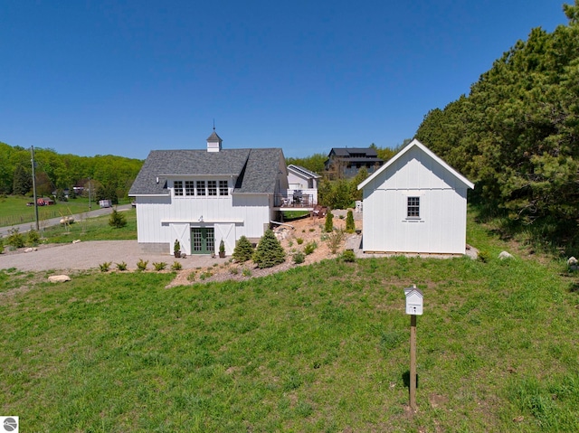 2494 N Setterbo Rd, Suttons Bay, MI 49682 - back of house with a lawn, french doors, and a shingled roof