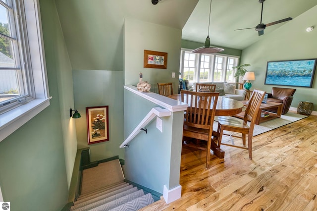 2494 N Setterbo Rd, Suttons Bay, MI 49682 - stairway with vaulted ceiling, wood finished floors, a ceiling fan, and baseboards