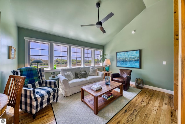 2494 N Setterbo Rd, Suttons Bay, MI 49682 - living room featuring ceiling fan, wood finished floors, high vaulted ceiling, and baseboards