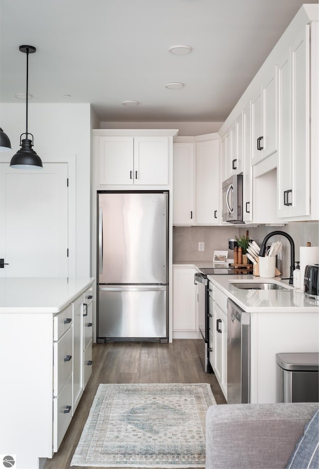222 E State St Unit 303, Traverse City, MI 49684 - kitchen featuring appliances with stainless steel finishes, a sink, and white cabinets