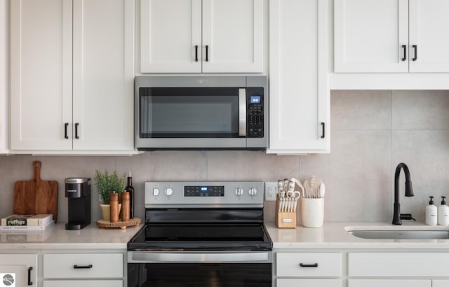 222 E State St Unit 303, Traverse City, MI 49684 - kitchen with stainless steel appliances, a sink, and white cabinetry