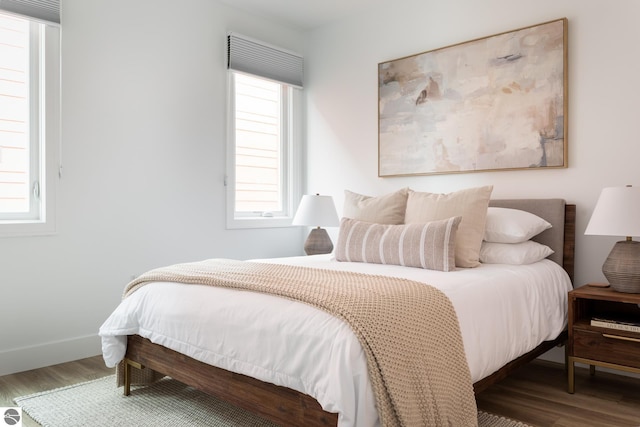 222 E State St Unit 303, Traverse City, MI 49684 - bedroom featuring wood finished floors and baseboards