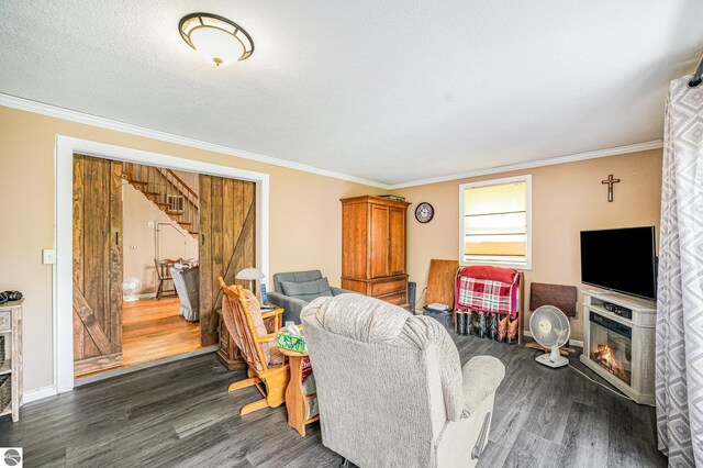 5817 Gross Dr, Weidman, MI 48893 - living room with stairway, dark wood-style flooring, ornamental molding, a glass covered fireplace, and baseboards