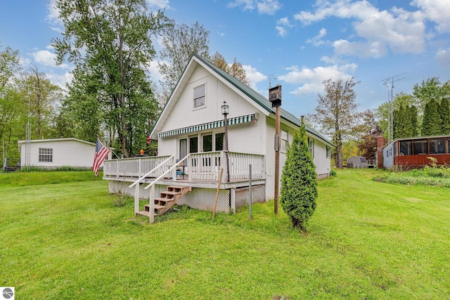 5817 Gross Dr, Weidman, MI 48893 - rear view of house featuring a wooden deck, a yard, and a chimney
