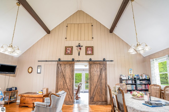5817 Gross Dr, Weidman, MI 48893 - dining area featuring a chandelier, wood finished floors, beamed ceiling, high vaulted ceiling, and wooden walls