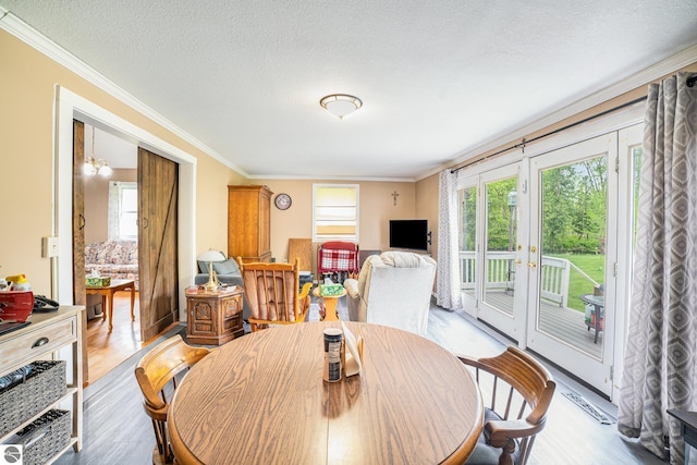 5817 Gross Dr, Weidman, MI 48893 - dining space with ornamental molding, light wood-style flooring, french doors, and a textured ceiling