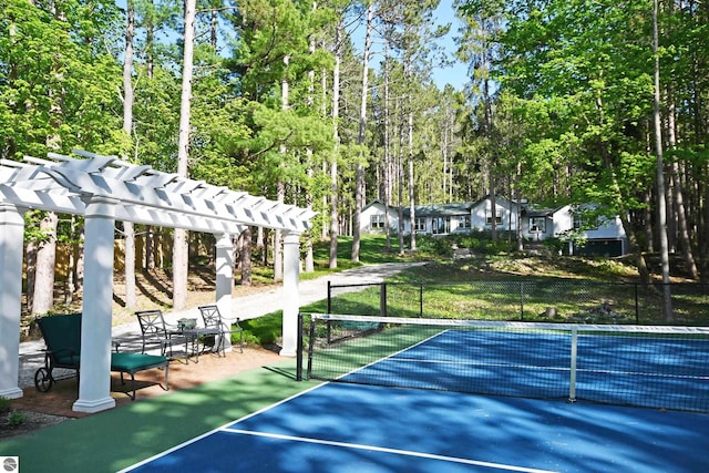 9017 S Dunns Farm Rd, Maple City, MI 49664 - view of tennis court with a pergola and view of scattered trees
