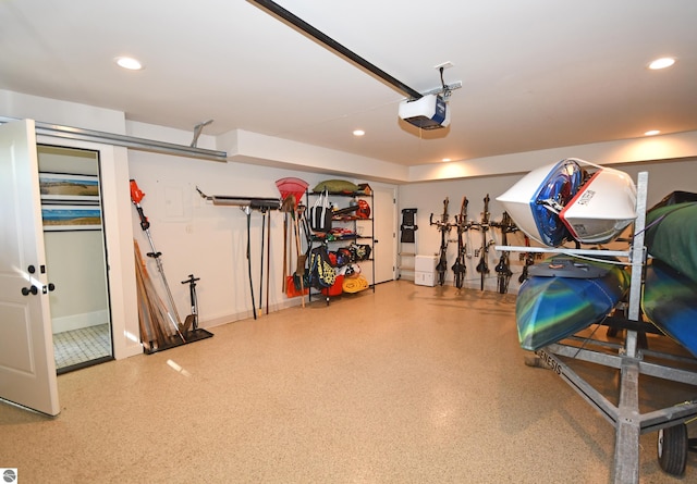 9017 S Dunns Farm Rd, Maple City, MI 49664 - garage featuring a garage door opener, recessed lighting, and baseboards