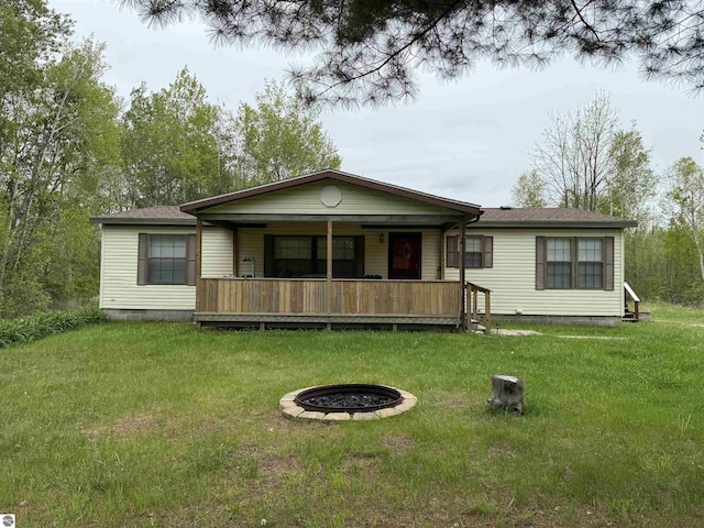 6661 Terry Ln, Hale, MI 48739 - view of front of property featuring crawl space, an outdoor fire pit, a front yard, and covered porch