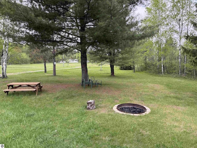 6661 Terry Ln, Hale, MI 48739 - view of green lawn featuring an outdoor fire pit