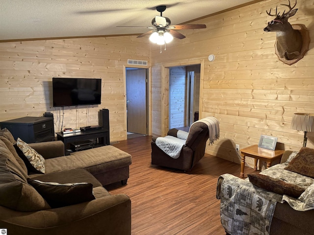 6661 Terry Ln, Hale, MI 48739 - living area with wood walls, ceiling fan, wood finished floors, lofted ceiling, and a textured ceiling