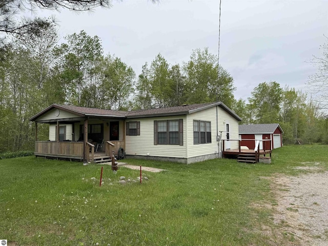 6661 Terry Ln, Hale, MI 48739 - view of front of property featuring an outbuilding, a front yard, a deck, and a porch