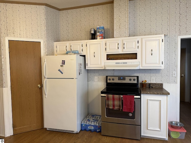 6661 Terry Ln, Hale, MI 48739 - kitchen featuring freestanding refrigerator, stainless steel electric range oven, under cabinet range hood, wallpapered walls, and dark wood-type flooring