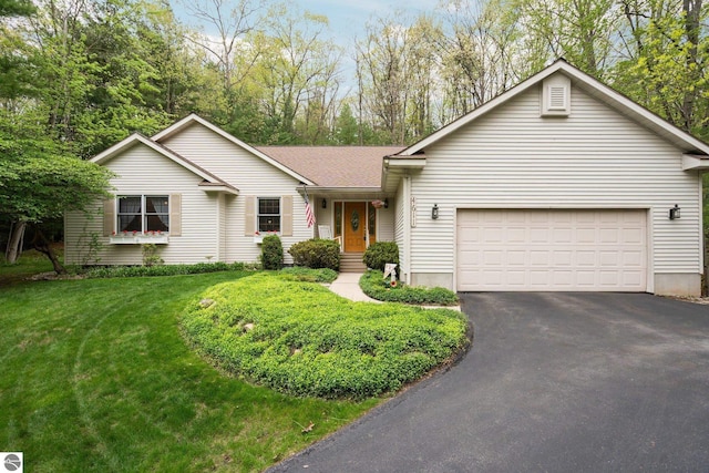4611 Audubon Dr, Traverse City, MI 49686 - single story home with asphalt driveway, an attached garage, a front yard, and a shingled roof