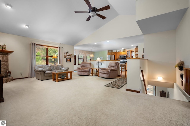 4611 Audubon Dr, Traverse City, MI 49686 - living room with a ceiling fan, light colored carpet, high vaulted ceiling, a brick fireplace, and recessed lighting