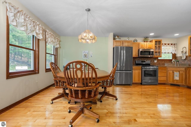 4611 Audubon Dr, Traverse City, MI 49686 - dining room with a chandelier, light wood finished floors, baseboards, and recessed lighting