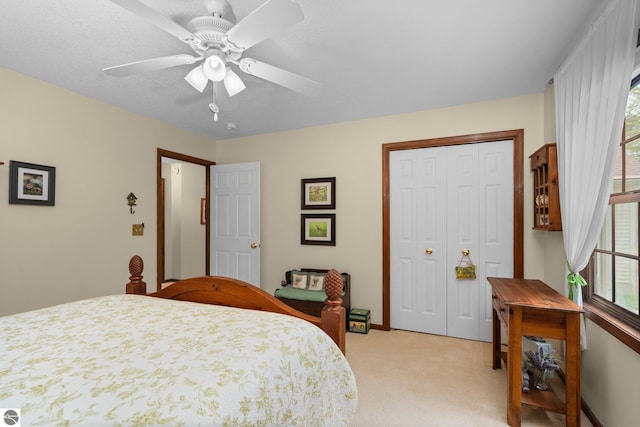4611 Audubon Dr, Traverse City, MI 49686 - bedroom with light colored carpet, multiple windows, a closet, and ceiling fan