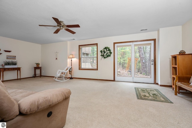 4611 Audubon Dr, Traverse City, MI 49686 - living area with light carpet, a ceiling fan, and baseboards