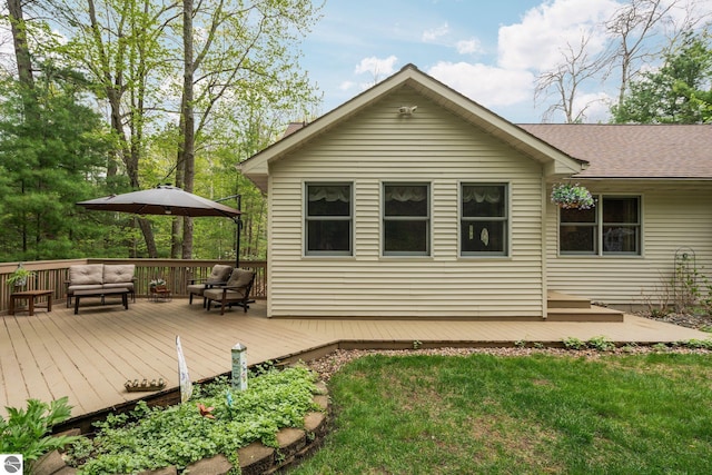 4611 Audubon Dr, Traverse City, MI 49686 - back of property featuring an outdoor hangout area, a wooden deck, and a yard
