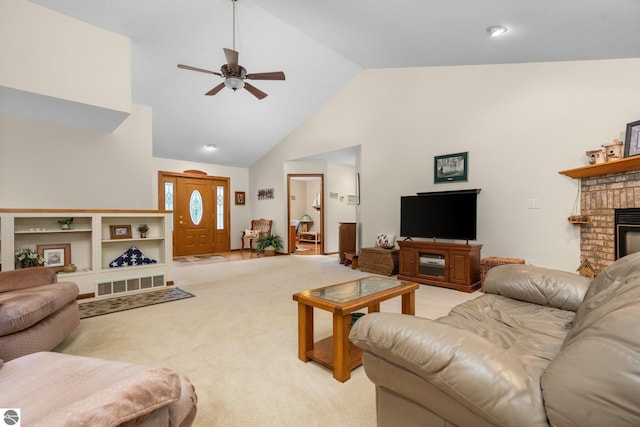 4611 Audubon Dr, Traverse City, MI 49686 - living area with a ceiling fan, light colored carpet, a fireplace, and high vaulted ceiling