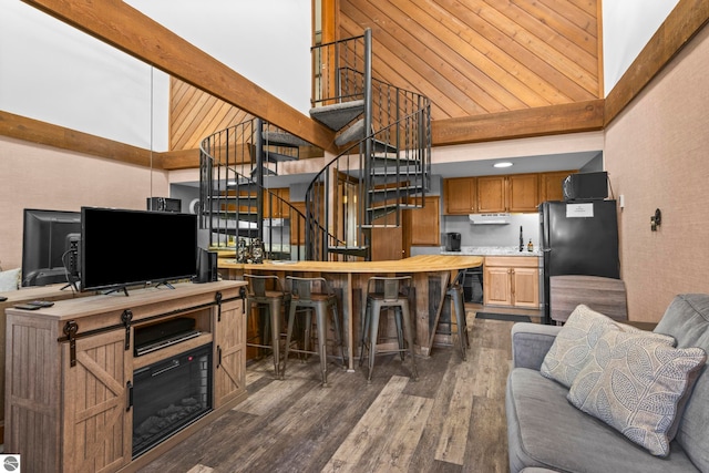 6519 Schuss Mountain Ln Unit 3511-3512, Mancelona, MI 49659 - living room featuring high vaulted ceiling, dark wood finished floors, and stairs