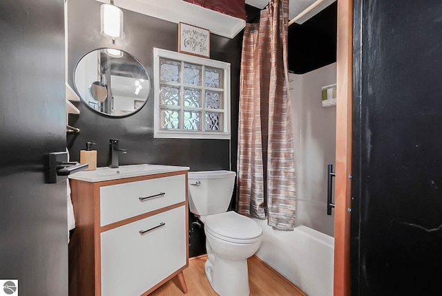 10092 S Elm St, Traverse City, MI 49684 - bathroom with wood finished floors, vanity, toilet, and shower / bath combo with shower curtain